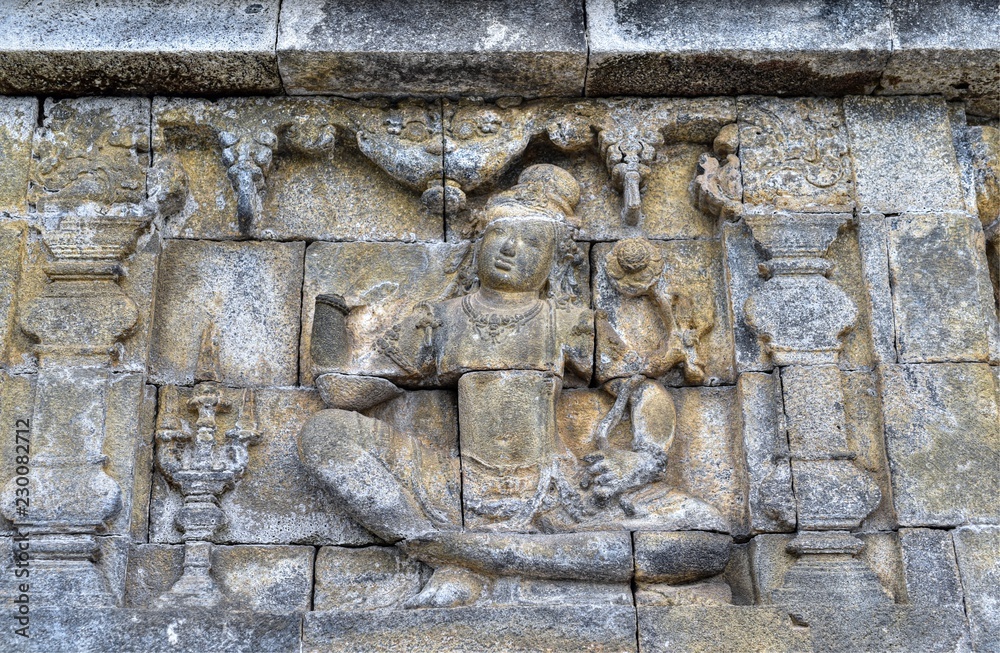 Beautiful bas-relief as wall decor carved in stone at Borobudur Temple, Yogyakarta, Indonesia