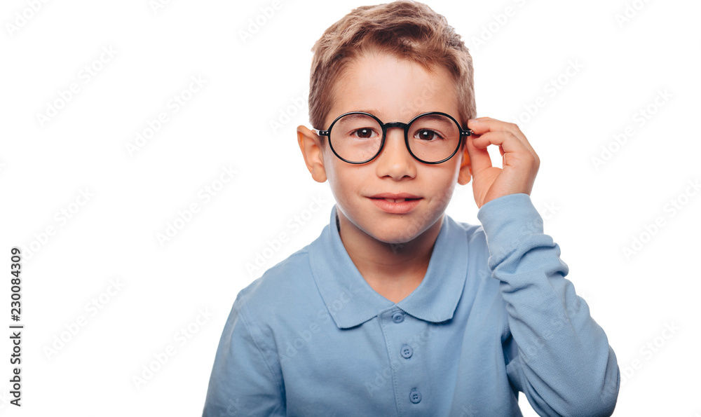 cucasian boy ajusting his eyeglasses and looking at camera over white background. Concept new eyeglasses for good vision cucasian boy ajusting his eyeglasses and looking at camera over white background. Concept new eyeglasses for good vision