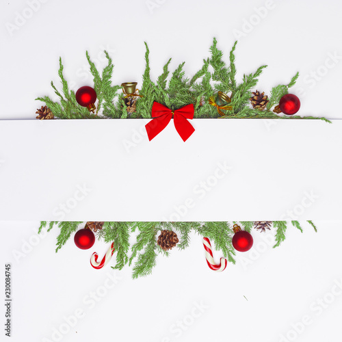 Fototapeta Naklejka Na Ścianę i Meble -  Christmas composition of coniferous branches, decorations and sweets. Flat lay. Top view Nature New Year concept. Copy space.