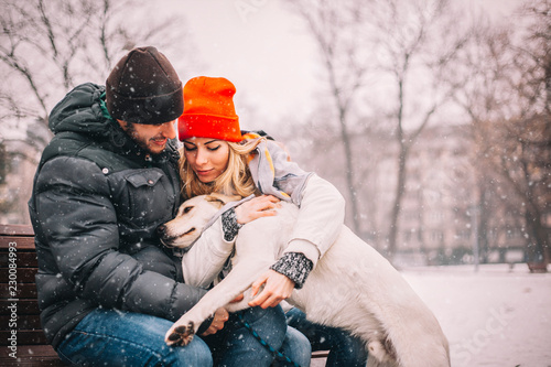 Young couple enjoy in park with his dog
