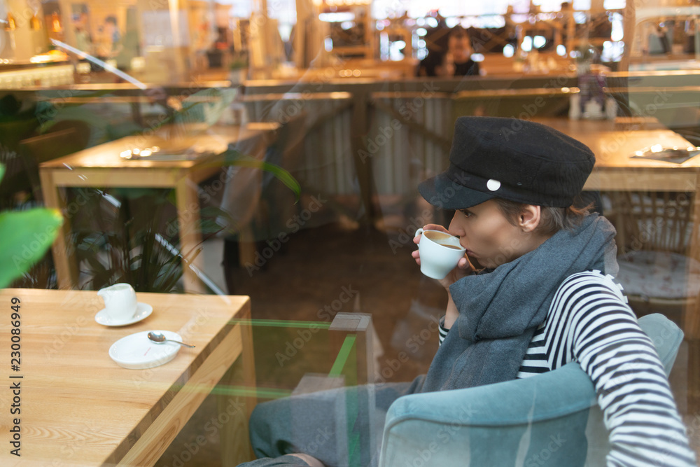 beautiful woman in hat and scarf drinking coffee while sitting in cafe
beautiful woman in hat and scarf drinking coffee while sitting in cafe