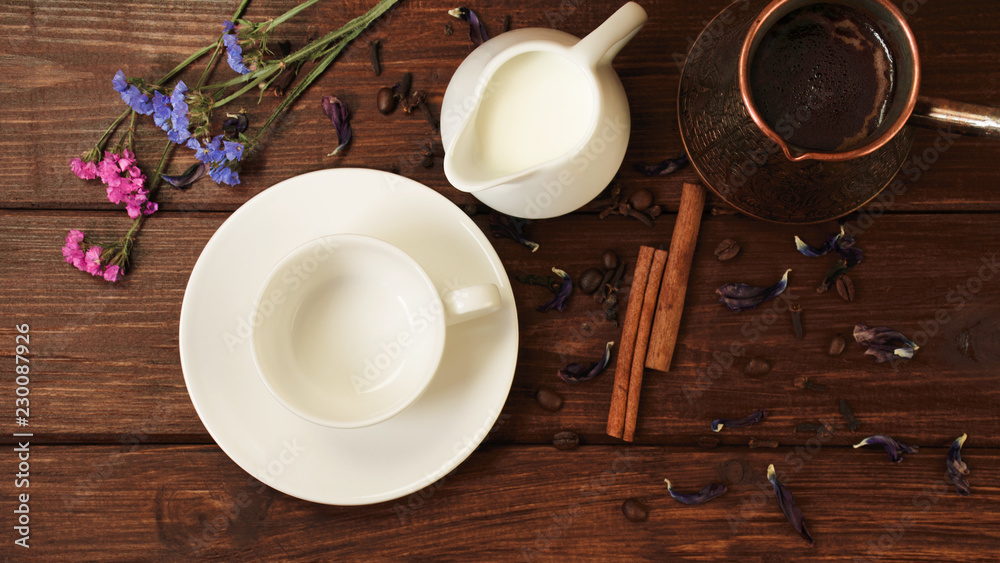 cup, milk, turk fresh coffee with cinnamon flowers on a dark wooden table cup, milk, turk fresh coffee with cinnamon flowers on a dark wooden table
