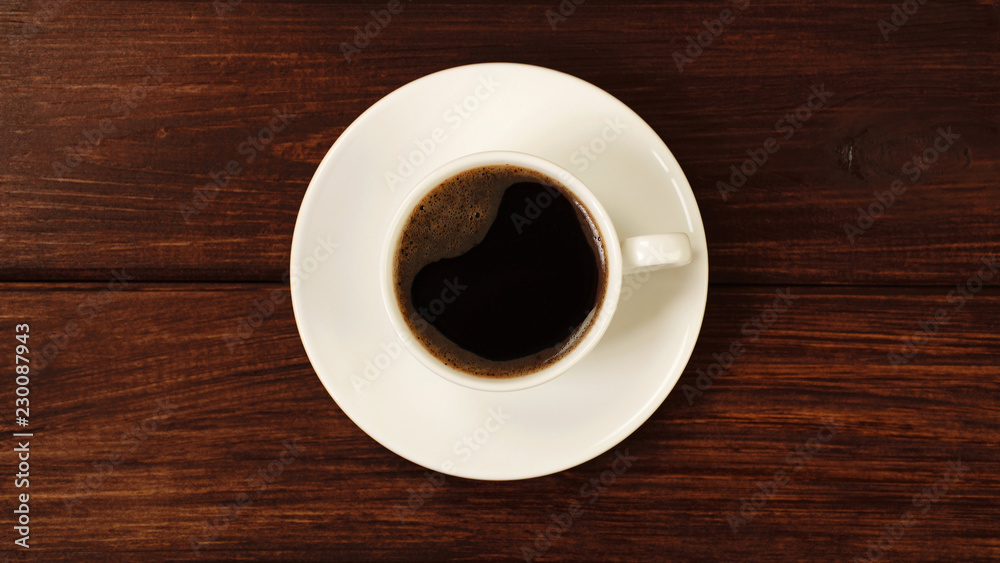 Cup of coffee on wooden table top view Cup of coffee on wooden table top view