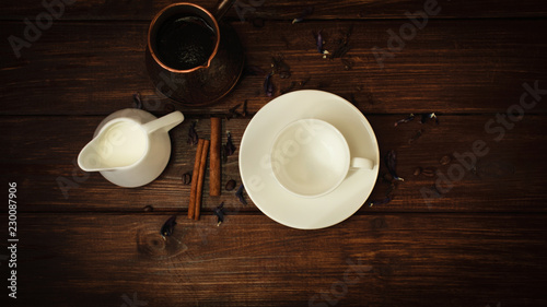 cup  milk and turk fresh coffee with cinnamon on a dark wooden table background