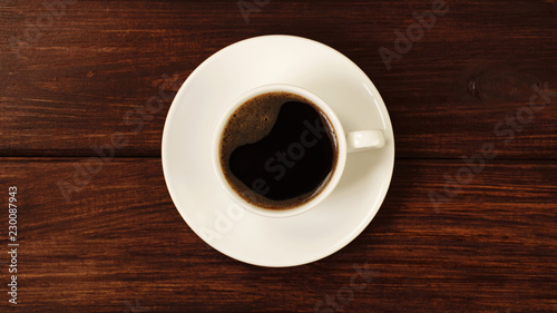 Cup of coffee on wooden table top view