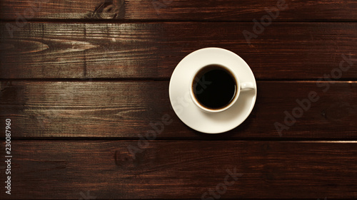 Cup of coffee on wooden table top view