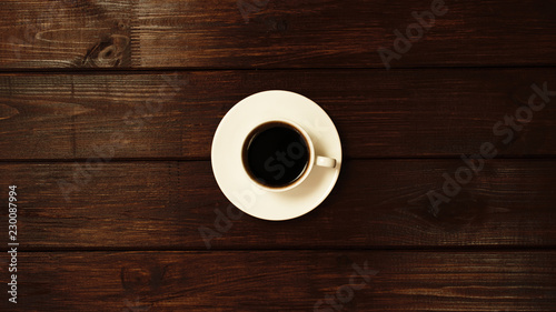 Cup of coffee on wooden table top view