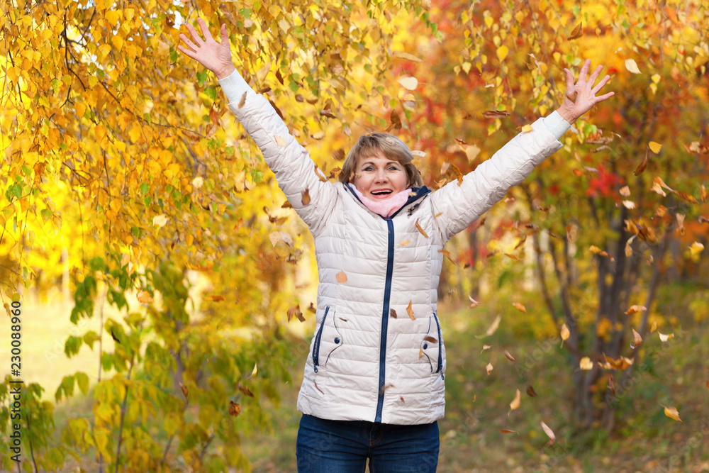 Portrait middle aged woman in autumn park Portrait middle aged woman in autumn park