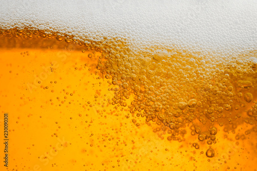 Beer background with bubble froth texture foam pouring alcohol soda in glass ...