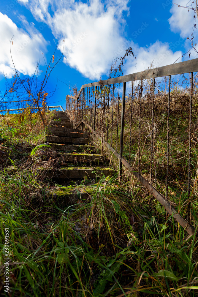 old abandoned metal staircase in the woods leading up
