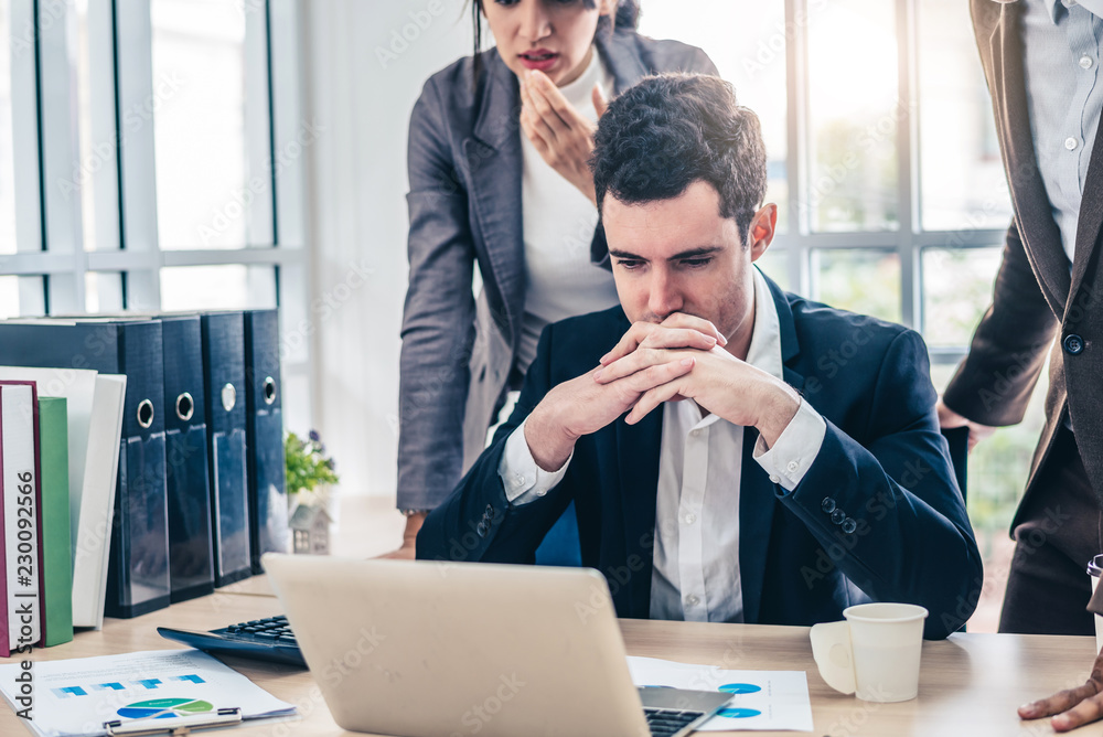 Businessman worry about his job with serious boss discussing while commenting a financial report document at meeting. Businessman worry about his job with serious boss discussing while commenting a financial report document at meeting.