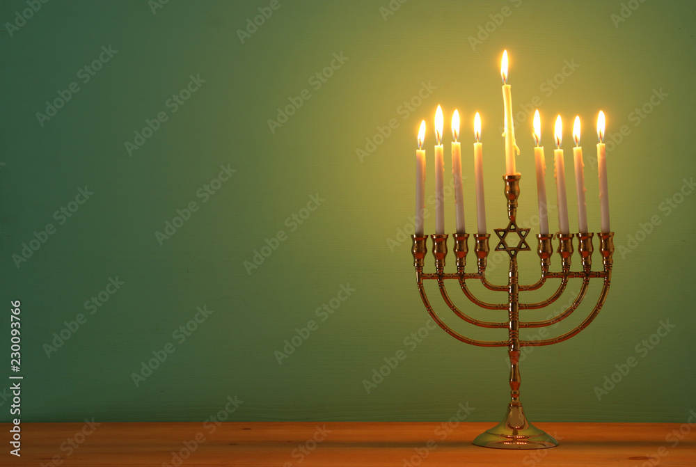 image of jewish holiday Hanukkah background with menorah (traditional candelabra) and candles. image of jewish holiday Hanukkah background with menorah (traditional candelabra) and candles.