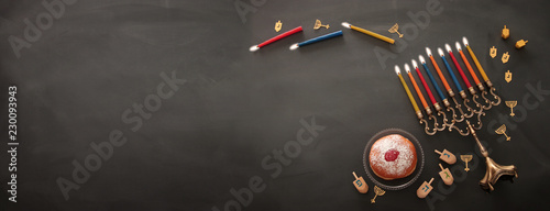 Banner of jewish holiday Hanukkah background with traditional spinnig top, menorah (traditional candelabra) and burning candles. photo