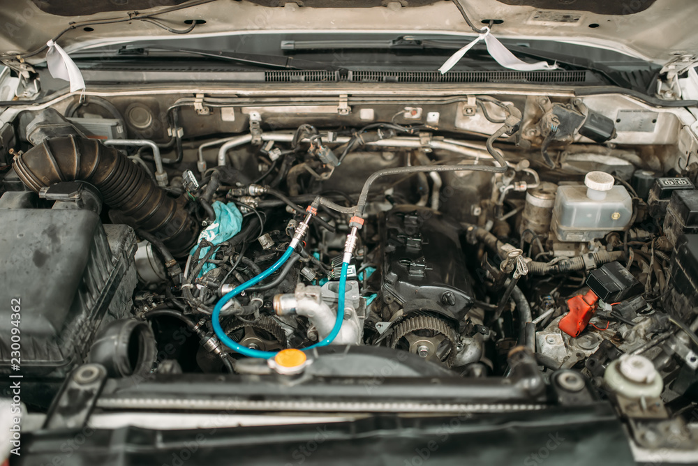 Car with opened hood, closeup view on engine Car with opened hood, closeup view on engine