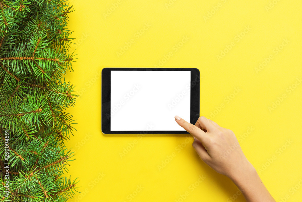 people and technology concept, close up of female hands pointing finger to tablet. blank screen on yellow background, top view people and technology concept, close up of female hands pointing finger to tablet. blank screen on yellow background, top view