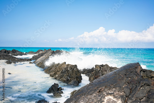 Waves breaking on lava rocks at beautiful Makalawena beach, Big Island Hawaii (United States)