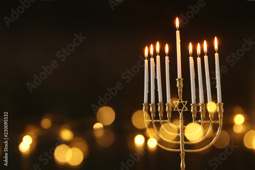 image of jewish holiday Hanukkah background with menorah (traditional candelabra) and candles. photo