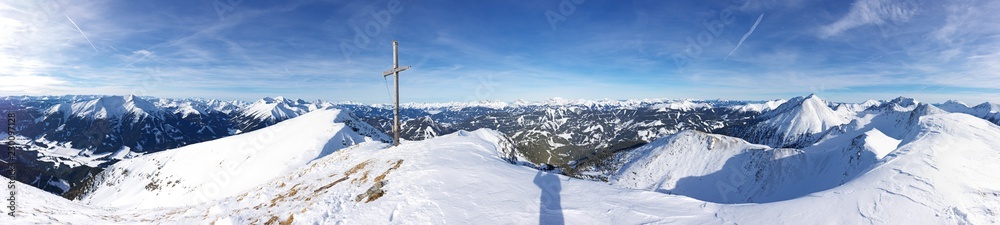 Alpine picturesque winter landscape panorama with high snowy mountains under sunny skies. Panoramic view from top of Styrian mountain Geierkogel, Steiermark, Austria.