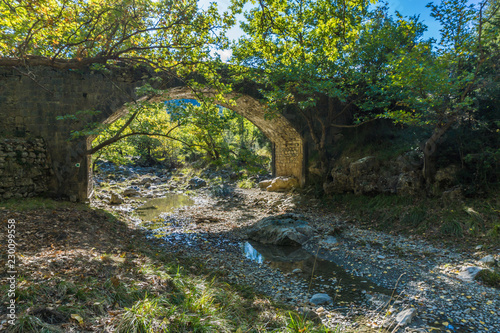 Fototapeta Naklejka Na Ścianę i Meble -  Tzavarainas stone bridge in Vitina village, a winter destination in mountainous Arcadia, in Peloponnese, Greece 