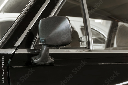 background - rearview mirror and door fragment of a vintage black car