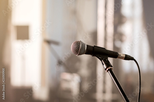 A microphone on stage in a concert hall or american bar (restaurant) during a show.