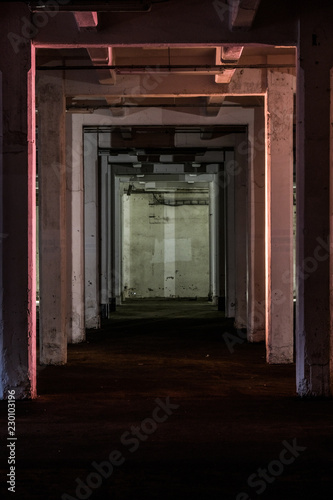 Illuminated poles in the basement of an industrial warehouse