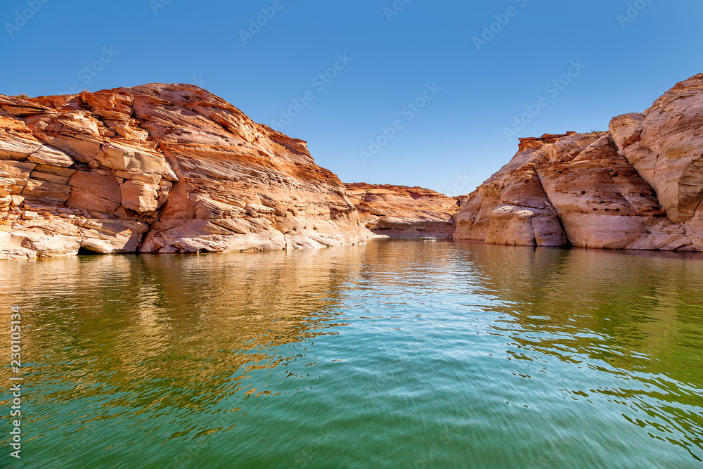 Glen Canyon coloured sandstone cliffs filled with water, near Lake Powell and the Colorado River, straddling the border between Utah and Arizona. National park and popular tourist attraction
