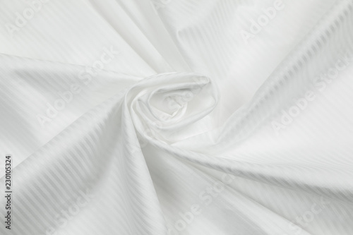 The monophonic matter of white color showing a beautiful drapery a spiral.  photo