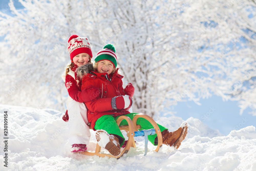 Kids play in snow. Winter sled ride for children Kids play in snow. Winter sled ride for children