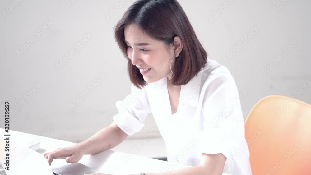 4k Young Asian woman working on computer and get a good result then happy 4k Young Asian woman working on computer and get a good result then happy