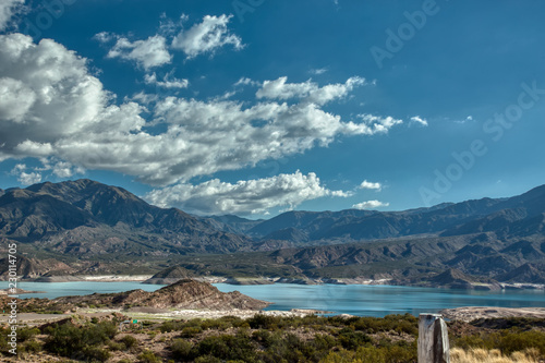 Potrerillos Dam Lake in Mendoza Argentina view of the Andes under a blue sky with cloud. photo