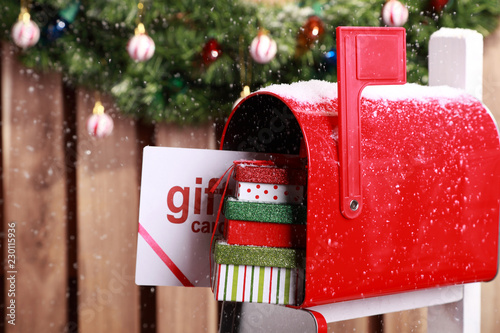 Obraz na plátně Red mailbox with Christmas gift card and presents