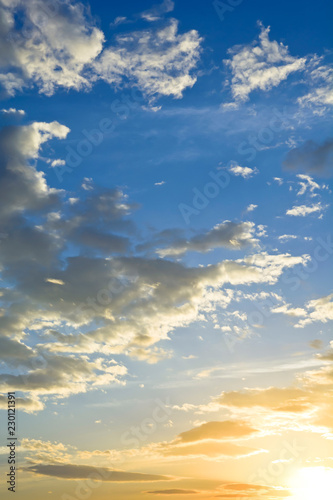Majestic sky with clouds at sunrise.
The sun smelling through the clouds against the sky.