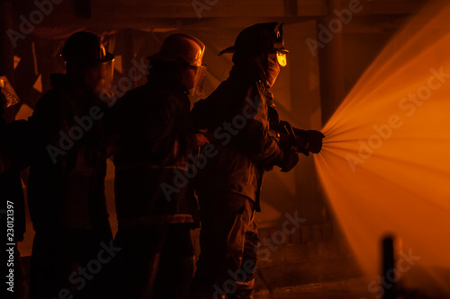 JOHANNESBURG, SOUTH AFRICA - OCTOBER, 2018 Firefighters spraying down fire during firefighting training exercise