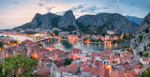 City of Omis, Dalmatia, Croatia. Blue hour landscape view in historical city centre of Omis and Cetina river. Popular holiday destination in Croatia