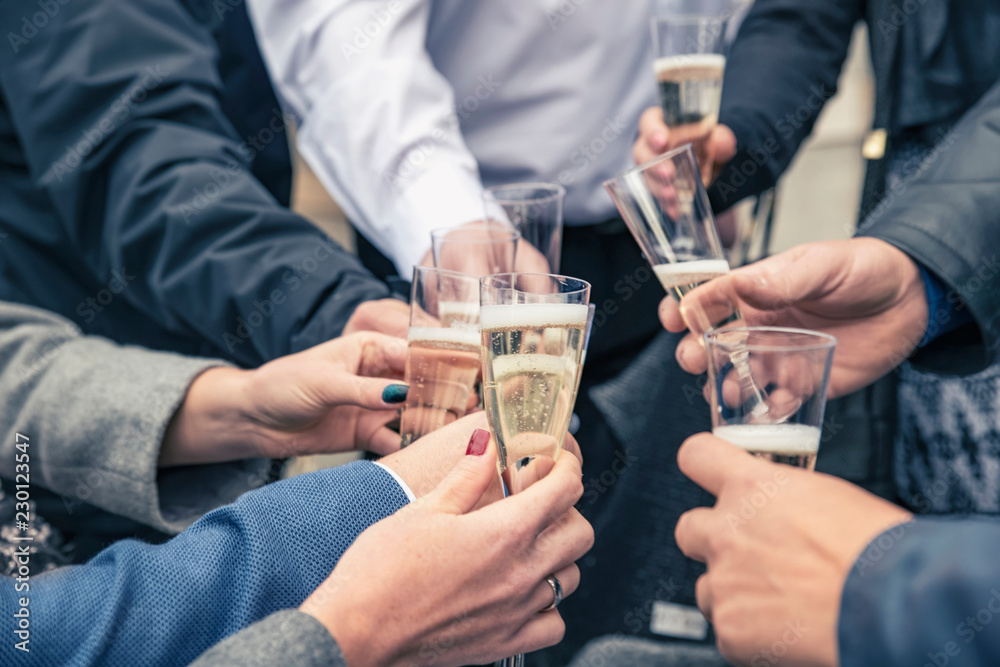 People celebrating a happy event clinking glasses of champagne,hands and glasses closeup. People celebrating a happy event clinking glasses of champagne,hands and glasses closeup.