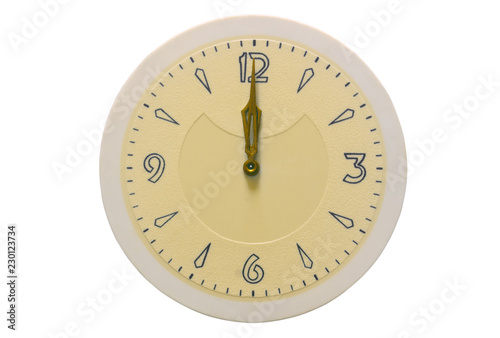 The dial and hands of the clock are showing on twelve on a white background.
