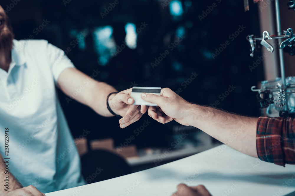 Closeup of Male Hand Gives Credit Card to Seller