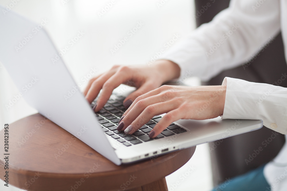 Woman's hands typing on laptop keyboard Woman's hands typing on laptop keyboard