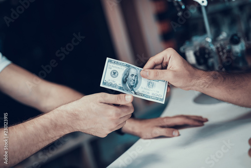 Closeup of Male Hand Gives Money to Seller