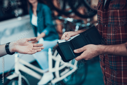 Closeup of Male Hand Gives Money to Seller photo