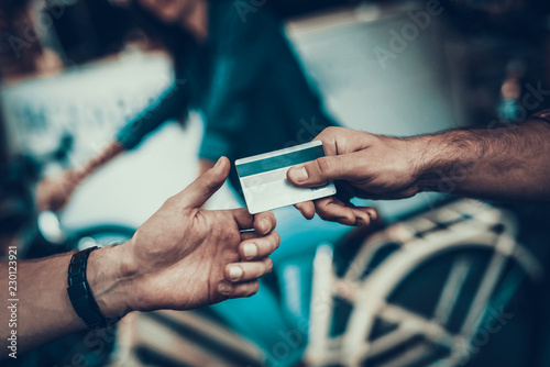 Closeup of Male Hand Gives Credit Card to Seller