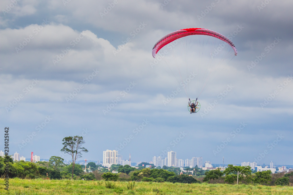 Man have fun with paraglider in a public park Man have fun with paraglider in a public park