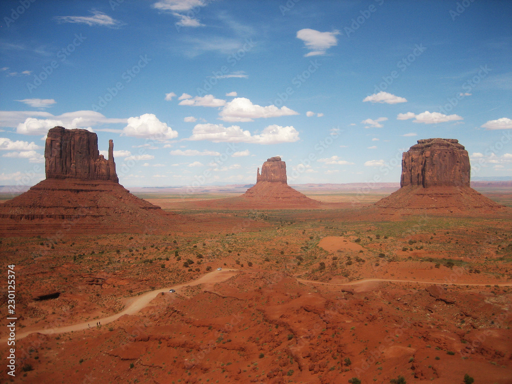 Landscape monument valley (USA) against blue sky with clouds Landscape monument valley (USA) against blue sky with clouds