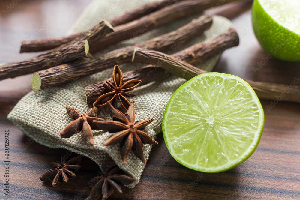 licorice root, lemon and anise on the table licorice root, lemon and anise on the table
