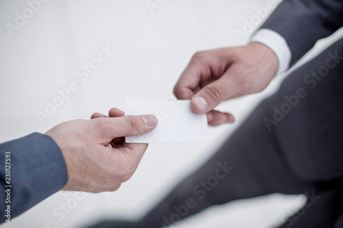 close up.business partners exchanging their business cards