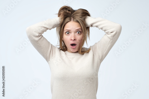 Portrait of young european woman with shocked facial expression