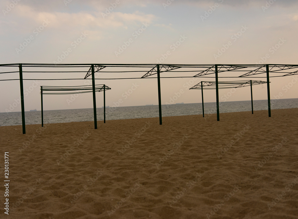 abstract metal construction on a sandy beach abstract metal construction on a sandy beach