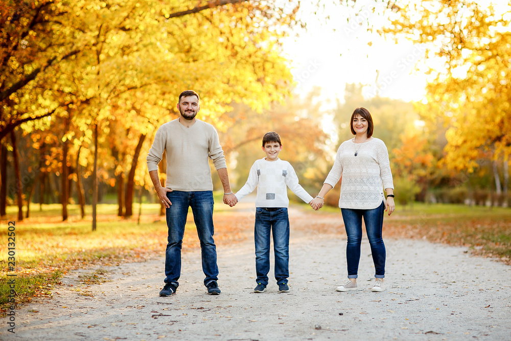 Happy family with teenage son outing in autumn park. Educational process, socialization of children. Happy family with teenage son outing in autumn park. Educational process, socialization of children.