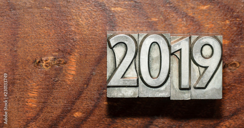 Year 2019 with types of press on a wooden background